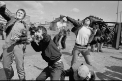 GB. NORTHERN IRELAND. Belfast. Men hurling rocks and molotov cocktails at security forces in the prelude to Bobby Sands funeral. 1981.