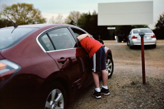 A boy gets a hug from his mother while they wait for Furry Vengeance at the Mansfield Drive in Theater.