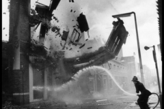 G.B. NORTHERN IRELAND. Belfast. A wall crumbles down after having been set on fire, presumably by the IRA.