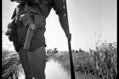 SOUTH VIETNAM. Delta region. A Vietcong (pro-Communist guerrilla), armed with a Kalashnikov gun, on the move in a sampan boat. He carries all his belongings on his back.