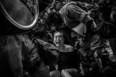 September 29, 2019 A man yells as he is detained by police after an altercation at the beginning of protest march near Causeway Bay. The mostly student-led protests seek several legislative actions to counter what they see as growing influence of mainland China in Hong Kong affairs. Photo by David Butow/Redux Pictures